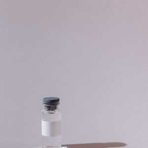 Clear research vial on neutral background